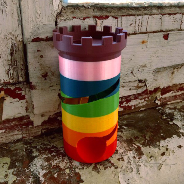 rainbow dice tower against an industrial chic backdrop of paint peeling